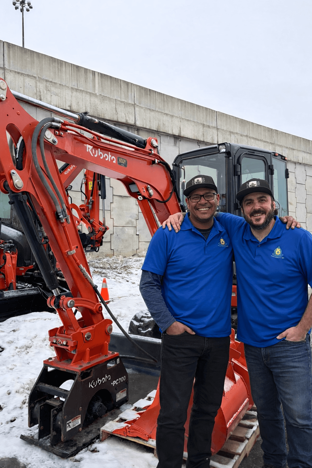 Aqua-Connections founders with Kubota excavator